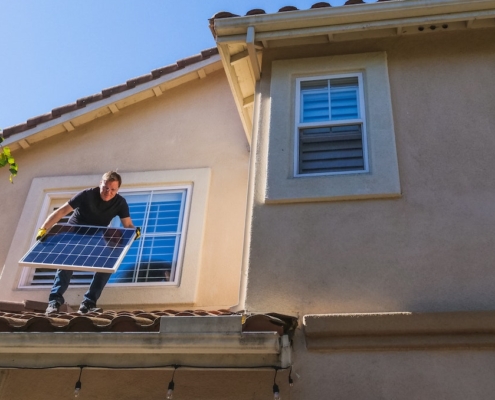 The Cost of Solar Installation: Is it Worth the Investment? Solar technician installing a solar panel on a residential home in Arizona.